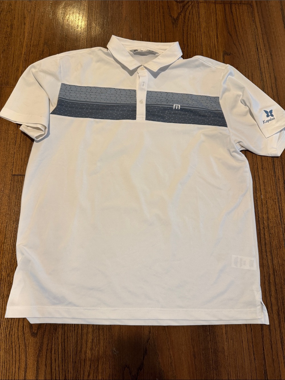 Travis Mathew Men’s White Polo with Blue Chest Stripe and Kapalua logo
